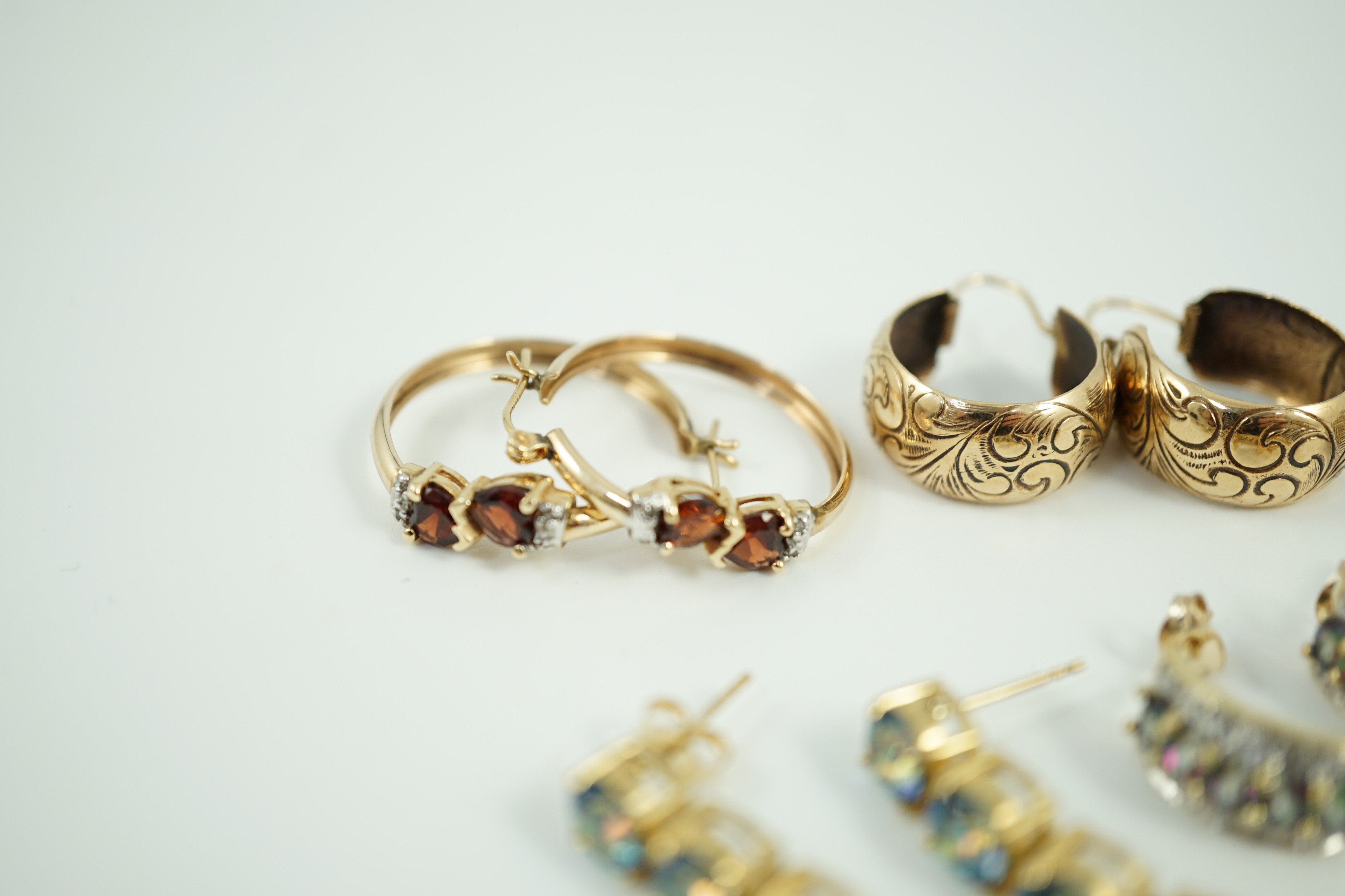 Four assorted modern pairs of 9ct gold and gem set earrings and one pair of yellow metal earrings, gross weight, 23.2 grams.
